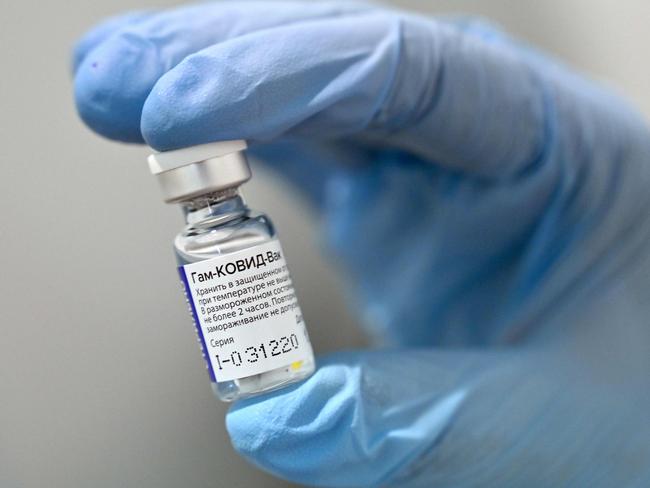 A health worker holds a vial of Russia's Sputnik V vaccine. Picture: AFP.