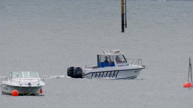 A police boat heads out to join the search. Picture: Andrew Henshaw