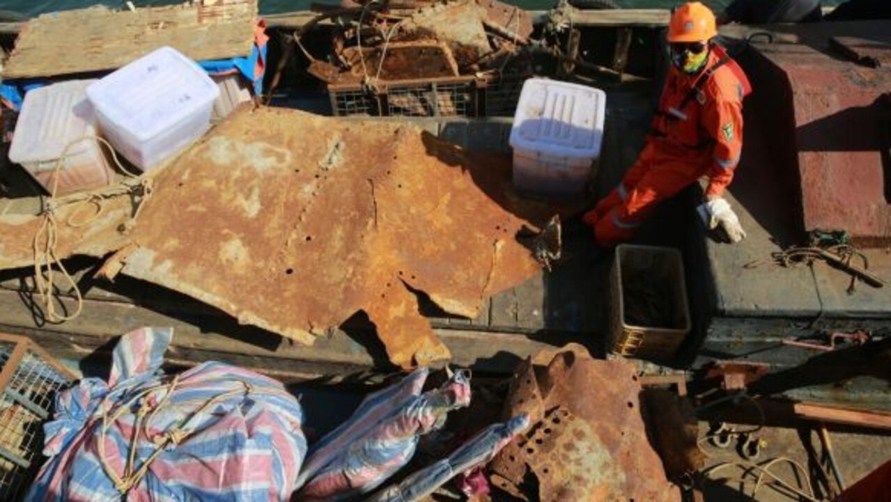 Workers transfer artefacts found from the long-lost warship Jingyuan in the sea area of Zhuanghe on September 25, 2018 in Dalian, Liaoning Province of China.