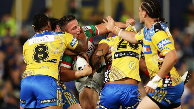 South Sydney's Sam Burgess is wrapped up by the Parramatta defence. Picture: Brett Costello