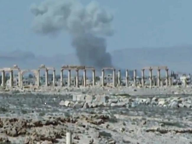 Smoke rises over the ancient ruins of Palmyra after the Islamic State took full control of the city after violent clashes with pro-government forces in 2015. The city was recaptured by the Syrian Army the following year.