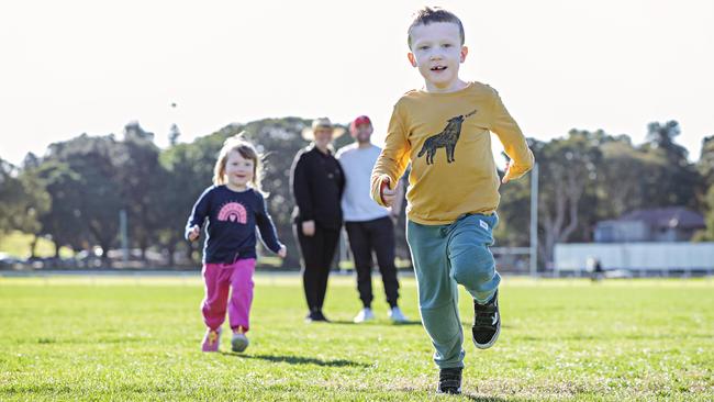 Edie and Owen Parker, watched by parents Claire and Michael Parker, enjoy an affordable outing. Picture: Adam Yip