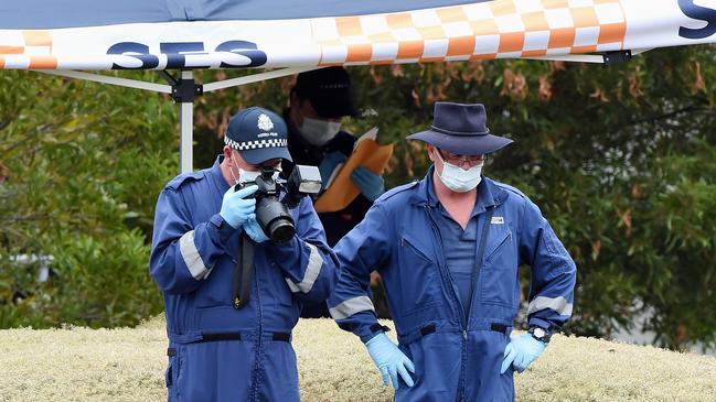 Forensic police photograph the scene. Picture: Lawrence Pinder