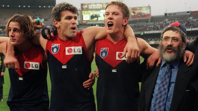 Then Melbourne president Joseph Gutnick, right, celebrates a Demons win over Collingwood with, from left, Travis Johnstone, Shaun Smith and Shane Woewodin.