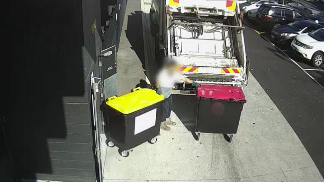 The bin collector wheeled both bins to the back of the truck. Picture: Supplied / ABC