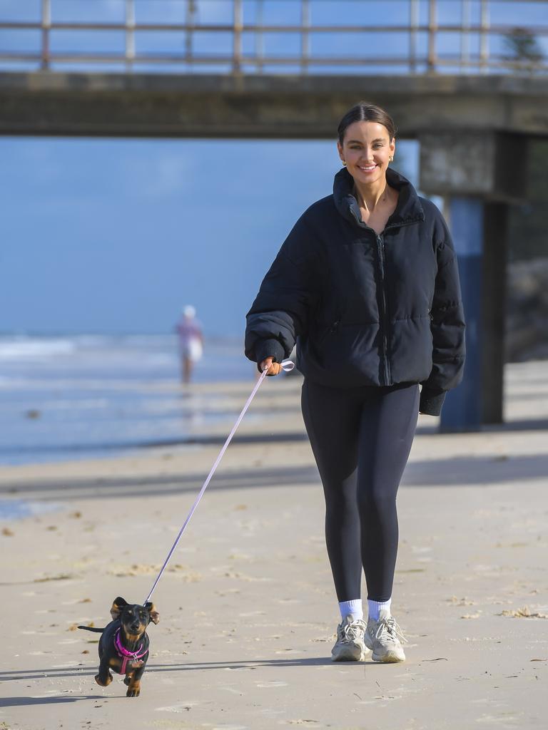 Lottie loves a walk with human Charlie Hayes at Brighton Beach. Picture: RoyVPhotography