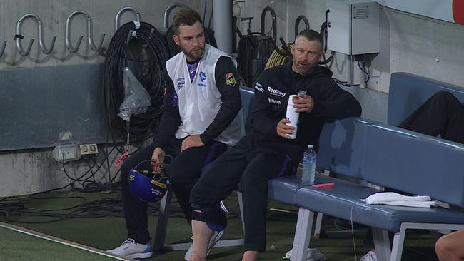 Caleb Jewell (left) and Matthew Wade (right) with ice and a compression sleeve on his right calf.