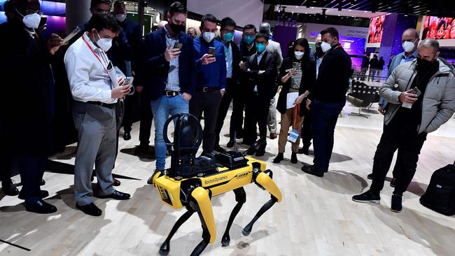 Visitors take pictures of Boston Dynamics' SPOT robot dog at the 2022 Mobile World Congress in Barcelona. Picture: AFP