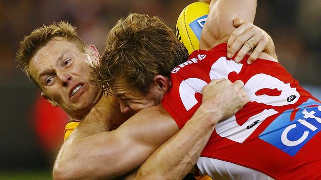 Sam Mitchell wraps up Luke Parker during last year’s clash at the MCG. Picture: Wayne Ludbey