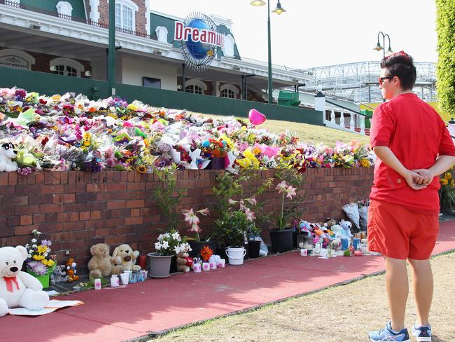 Members of the public pay tribute at Dreamworld on Friday. Picture: Tertius Pickard/Getty Images