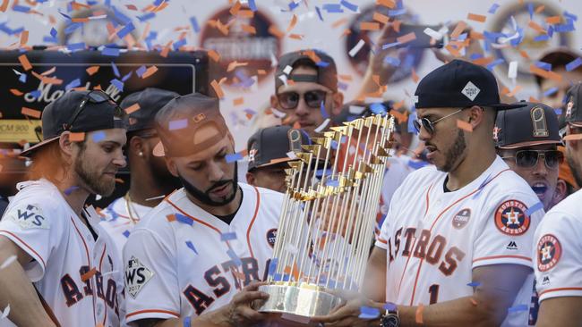 Marwin Gonzalez and Carlos Correa World Series Trophy after the 2017 win.