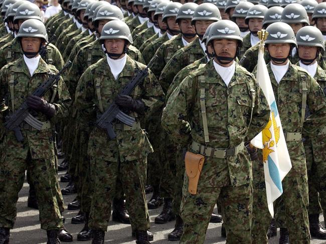 OCTOBER 5, 2003 : Japanese soldiers of Ground Self-Defence Force salute during annual inspection parade of the JGSDF East Area division in 05/10/03 file photo.Japan / Armed Forces / Army