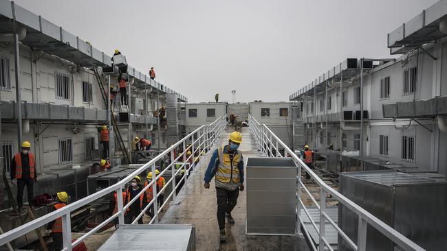 Workers on the finishing touches to Wuhan’s Huoshenshan Hospital on Sunday. Picture: Getty Images