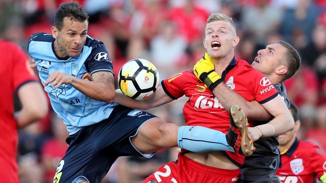 Sydney FC striker Bobo clashes with Adelaide’s Jordan Elsey. Picture: AAP