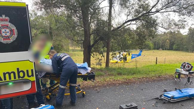 A woman being treated by paramedics following a carsh east of Gympie. Photos: Lifeflight