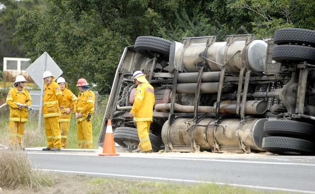 Rural firefighters on standby after a truck rolled  over on Bangalow Road near Binna Burra. Picture: Jay Cronan