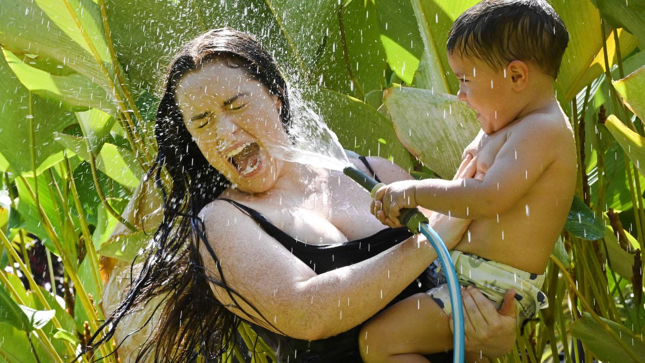 Hot weather will engulf the Top End. Elle Richardson and son Duke Kickett found a way to stay cool. Picture: Julianne Osborne