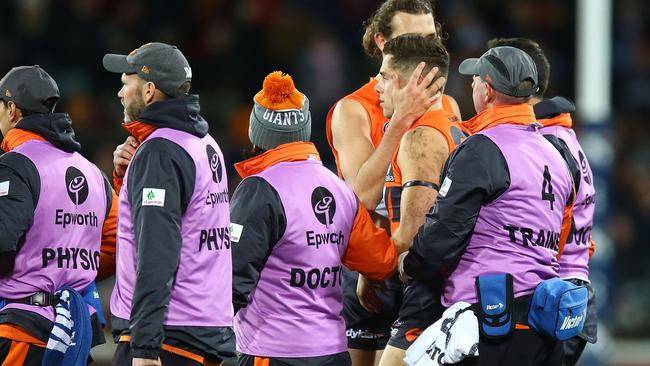 Josh Kelly is helped off after recovering.