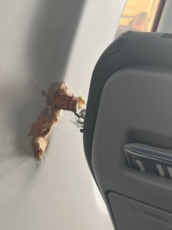 A passenger on board a Link Airways flight from Canberra on Thursday took pictures of the incident, which resulted in a ratchet strap penetrating the cabin fuselage.