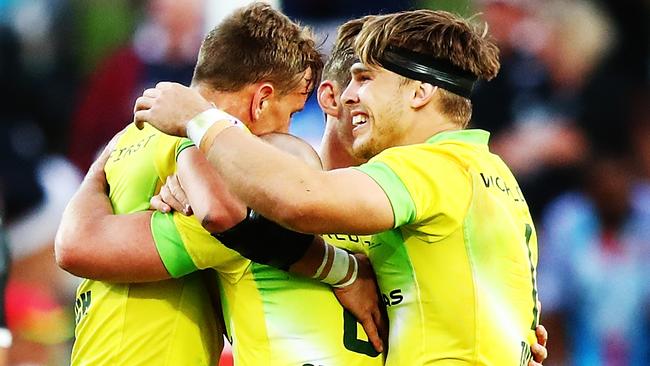 The Aussies mob James Stannard after his drop goal secured the Bronze Medal against New Zealand. Picture: Getty Images