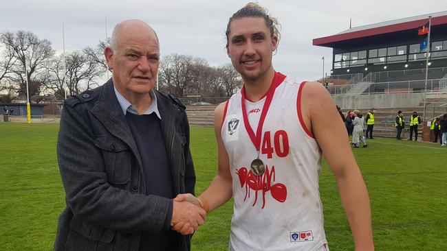 Harold Martin congratulates best-on-ground Daniel Hughes. Picture: Ben Higgins