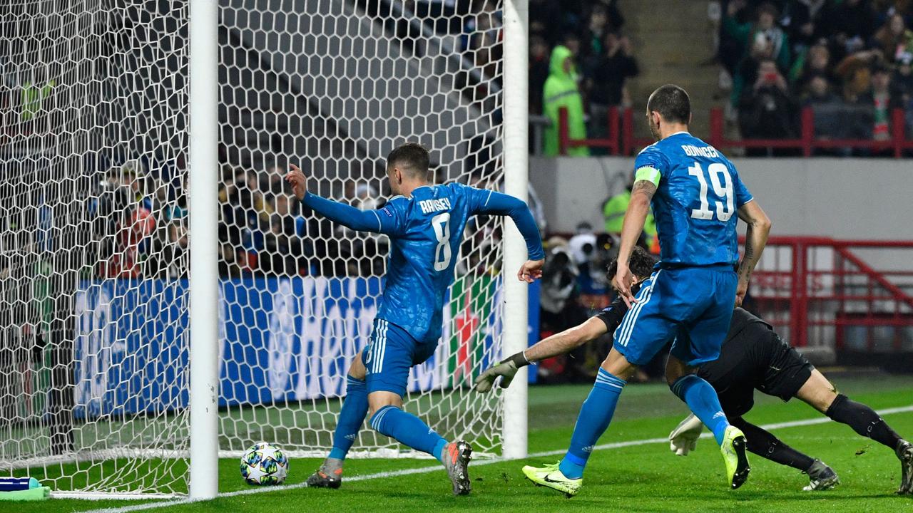 Aaron Ramsey pokes home Cristiano Ronaldo’s free-kick.