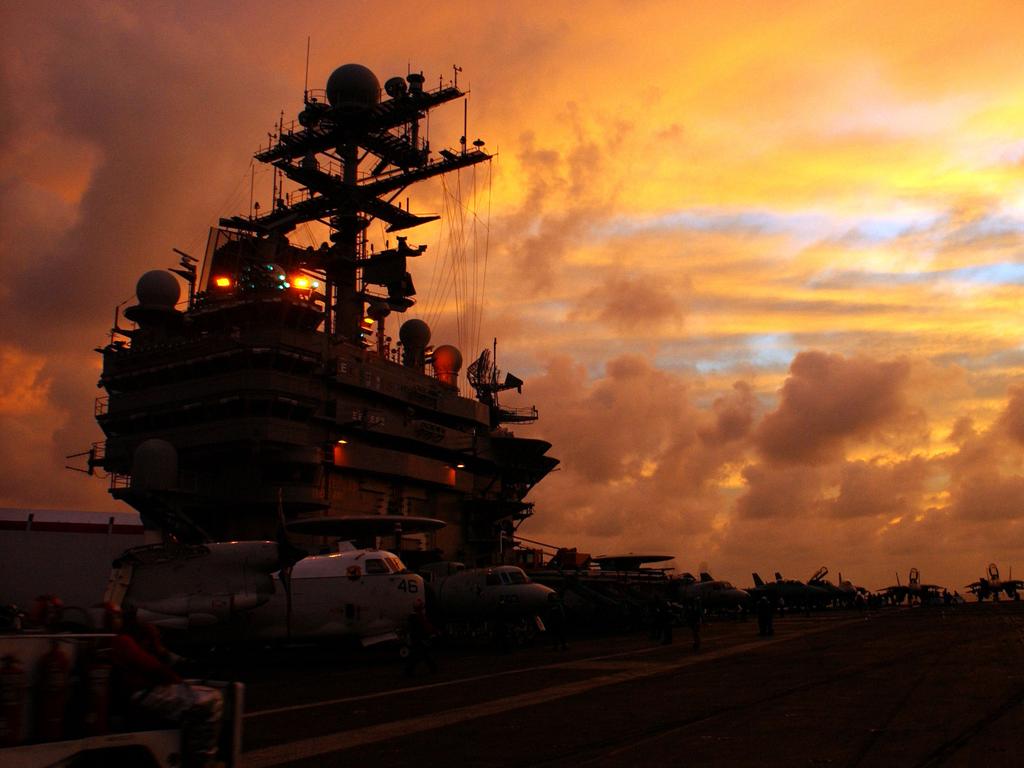 The Nimitz-class aircraft carrier USS Harry S. Truman is silhouetted during a sunset. The ability of such ships to survive a modern battlefield is being questioned. Picture: USN