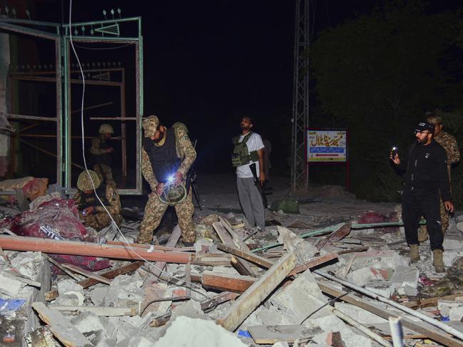 Army soldiers examine a building damaged by a suspected Indian missile attack near Muzaffarabad, the capital of Pakistan-controlled Kashmir. Picture: AP