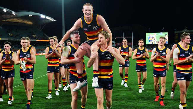 Adelaide Crows ruckman Sam Jacobs is chaired off by Bryce Gibbs and Rory Sloane for his 200th game at Adelaide Oval in Round 22. Picture: Mark Brake/Getty Images