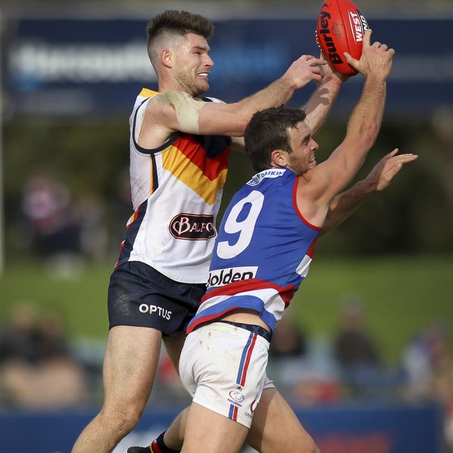 Jydon Neagle, right compete with Adelaide’s Bryce Gibbs in the SANFL in 2019.