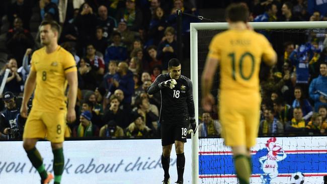 Adam Federici (centre) in between Bailey Wright and Robbie Kruse.