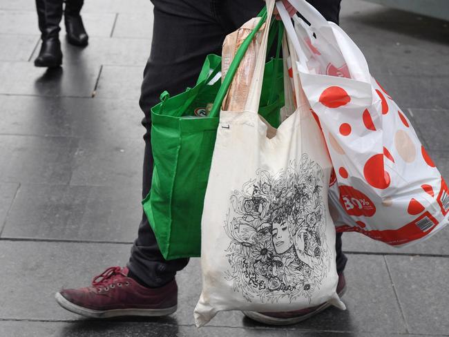 A shopper is seen carrying bags at a Coles Sydney CBD store, Sydney, Monday, July 2, 2018. Woolworths says it will hand out free reusable bags for the next 10 days as its customers get used to its ban on single-use plastic bags. Woolies stores in NSW, Queensland, Victoria and Western Australia stopped providing free single-use plastic bags on June 20. (AAP Image/Peter RAE) NO ARCHIVING