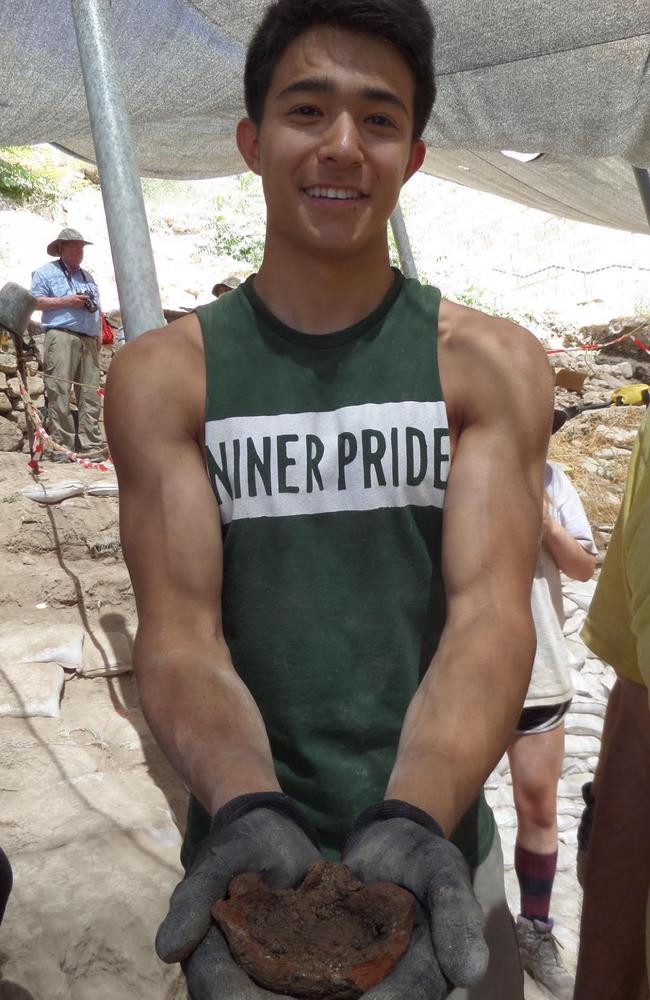 Miles Shen, one of the students from the UNC Charlotte's Levine Program holding a lamp dating from the Iron Age. Source: Mt Zion Archaeological Expedition/James Tabor.