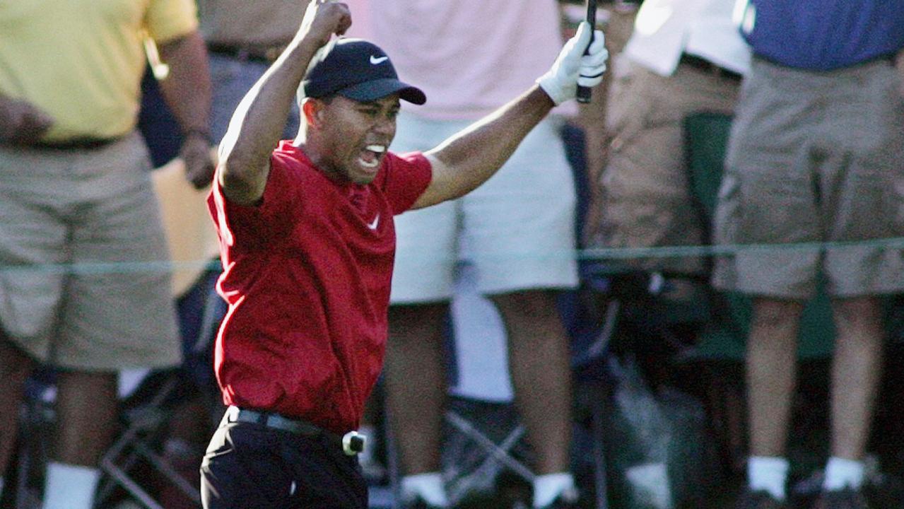 Tiger Woods reacts after his chip-in birdie on 16th hole during the final round of the 2005 Masters