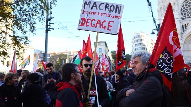 A protester holds a placard reading “(French President) Macron, you stink, get out” during a rally in Marseilles on Thursday as part of a day of action and strike in the public sector. Picture: Clement Mahoudeau / AFP