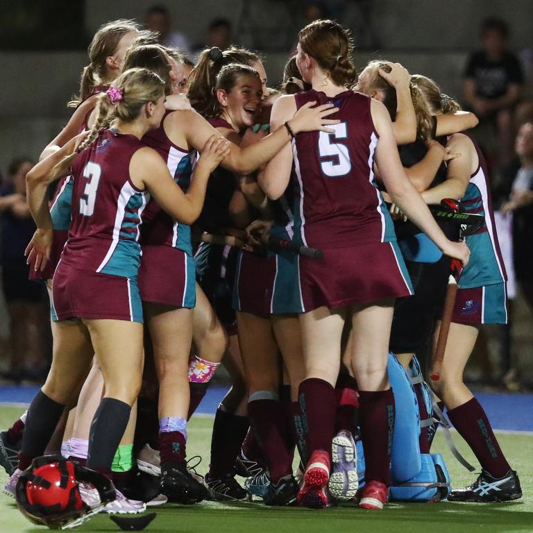 Brothers players rush in to hug goal keeper Ella McLeod after she stopped a goal attempt by Saints' Talytha Macdonald to win the penalty shootout and the match for her team in the Cairns Hockey Association Under 18A Women's grand final between Brothers and Saints. PICTURE: BRENDAN RADKE