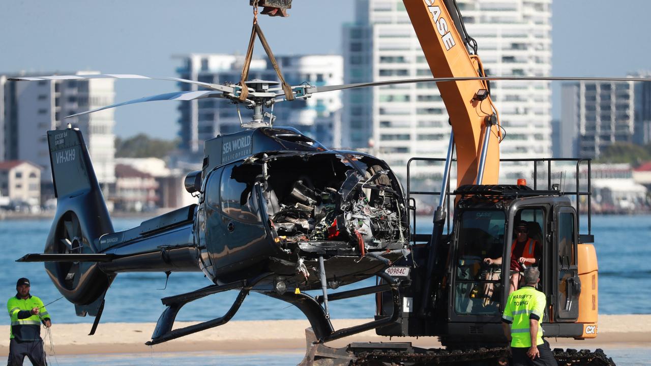 Queensland Police and Australian Transport Safety Bureau officers recover the wreckage of a helicopter after it collided with another helicopter near Sea World on the Gold Coast. Picture: Scott Powick