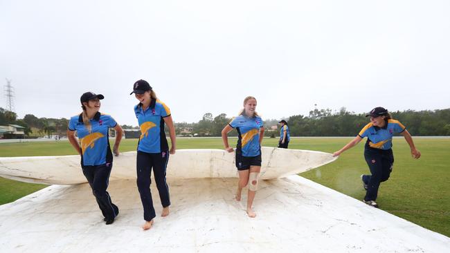 Gold Coast Dolphins women's players after rain forced the cancellation of play in a one-day premiership attempt. Photograph : Jason O'Brien