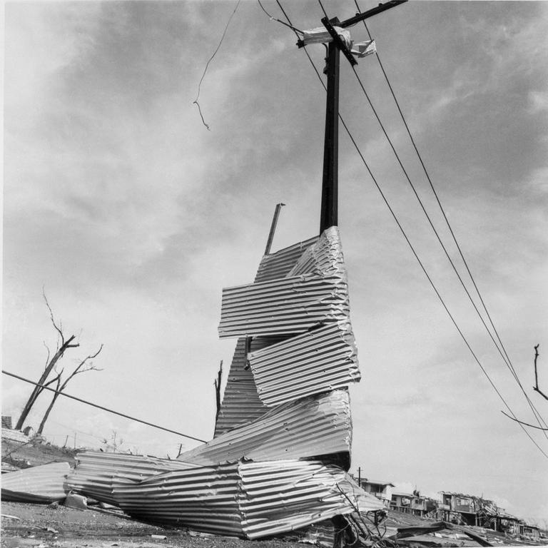 Corrugated iron wrapped around a power pole after Cyclone Tracy. Supplied/MAGNT