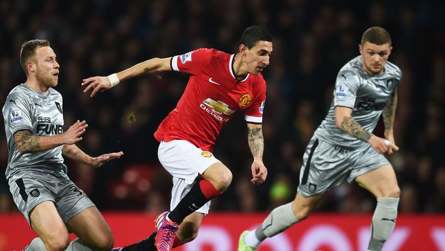 Angel Di Maria of Manchester United skips away from Scott Arfield of Burnley.