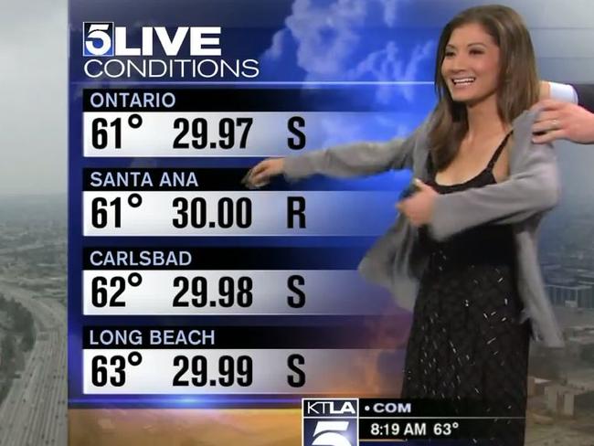 Chan puts on the cardigan after being told viewers had complained about her dress. Picture: KTLA