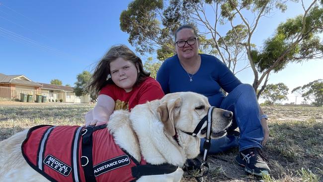 Murrianna Reese and her son Logan with his assistance dog Hunter. Picture: Dylan Hogarth