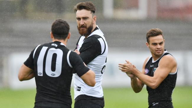 Travis Boak gives advice to Charlie Dixon and Karl Amon at Alberton on Thursday morning. Picture: AAP Image/David Mariuz