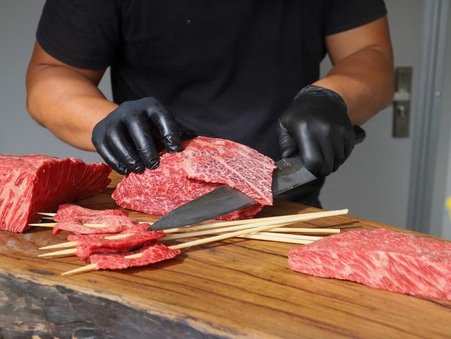 Firepop co-owner Ray Hou slicing Wagyu. Picture: Jenifer Jagielski