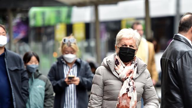 People are choosing to wear masks outdoors as Covid cases rise in Melbourne. Picture: Nicki Connolly