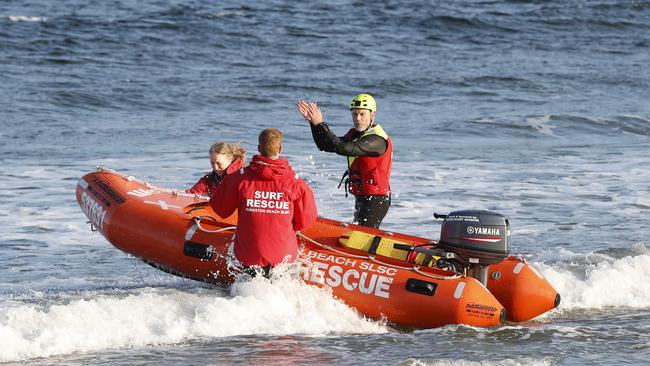 Members from Kingston Beach Surf Life Saving Club. Boat washed up on Kingston Beach with no one on board. Picture: Nikki Davis-Jones