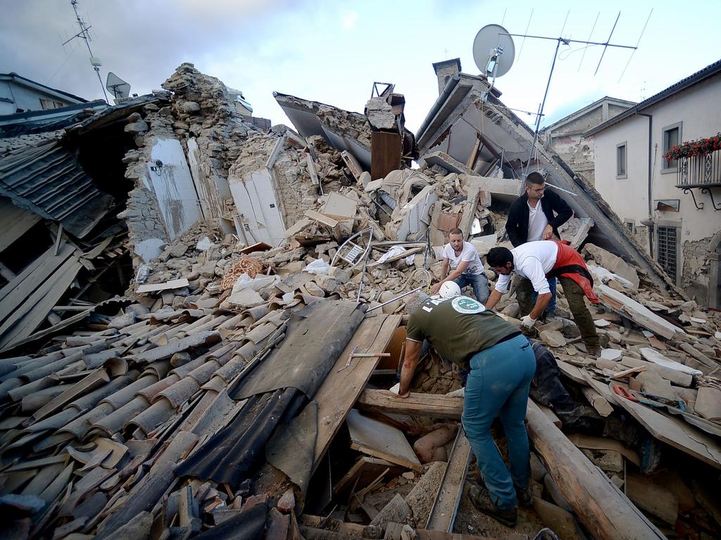 Residents search for victims in the rubble after a strong earthquake hit Amatrice on August 24, 2016. Picture: AFP