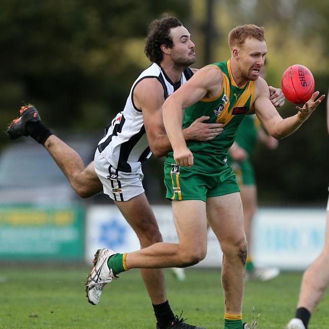 Leongatha’s Luke Bowman juggles a mark in front of Sale’s Will Leslie. Picture: Yuri Kouzmin