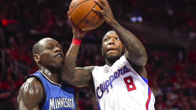 Los Angeles Clippers guard Nate Robinson drives past Minnesota Timberwolves center Gorgui Dieng.