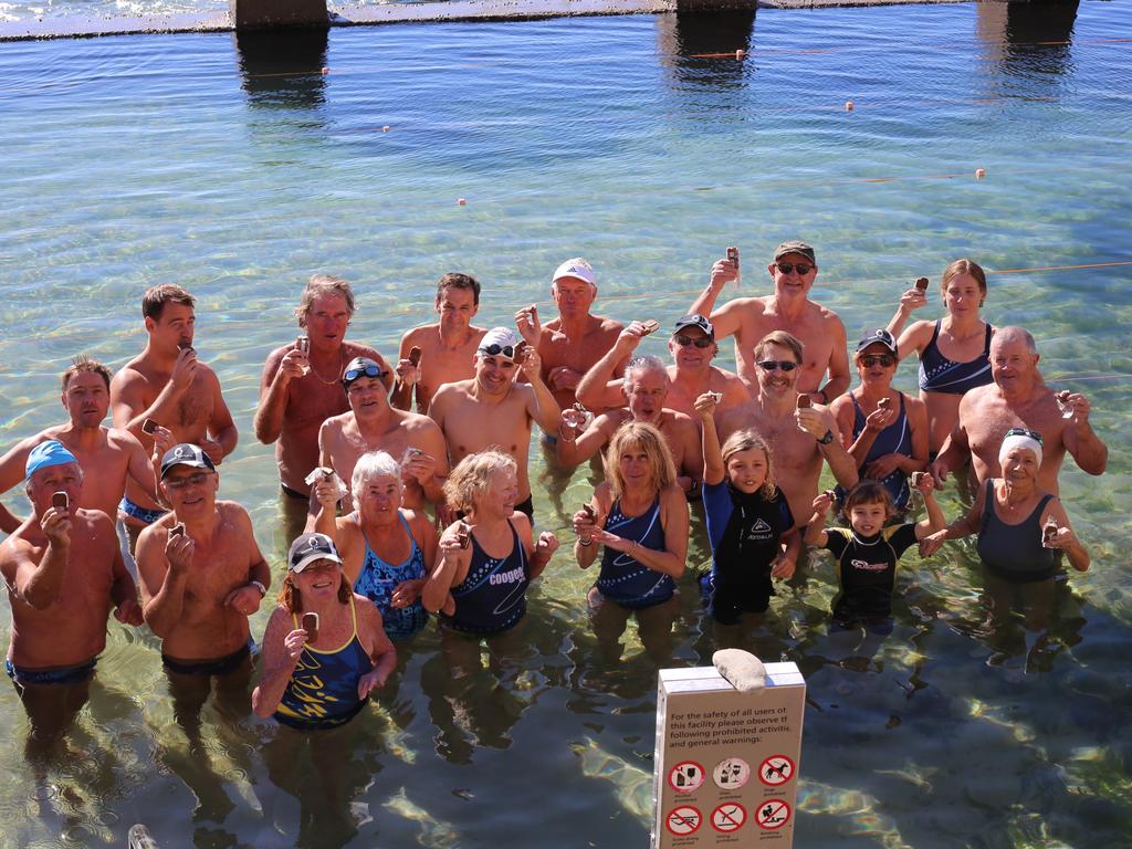 Coogee Penguins eating Eskimo Pie ice creams at Coogee, recreating a photo from 1952.